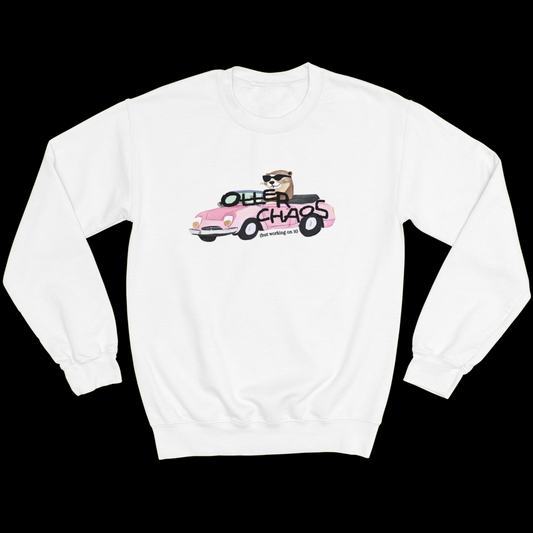 White crewneck sweatshirt with a graphic on the front of an otter driving in a pink car with the words "Otter Chaos" written on the front.